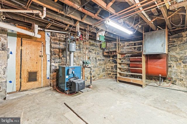 unfinished basement featuring a heating unit