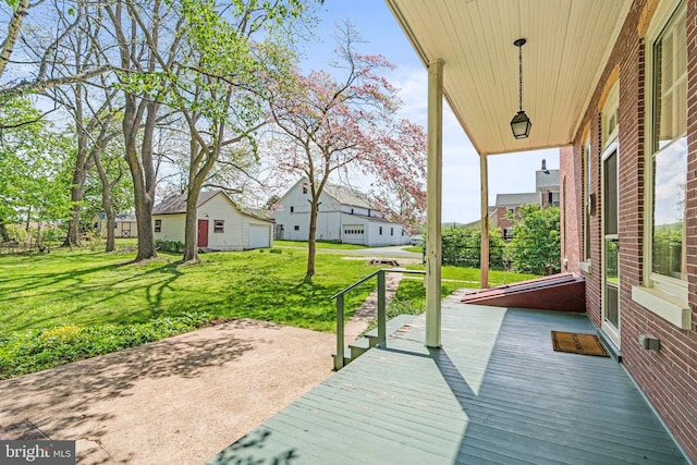 wooden terrace with a yard, a residential view, and a patio area