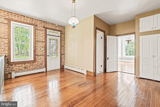 entrance foyer featuring baseboards, a baseboard radiator, and light wood finished floors