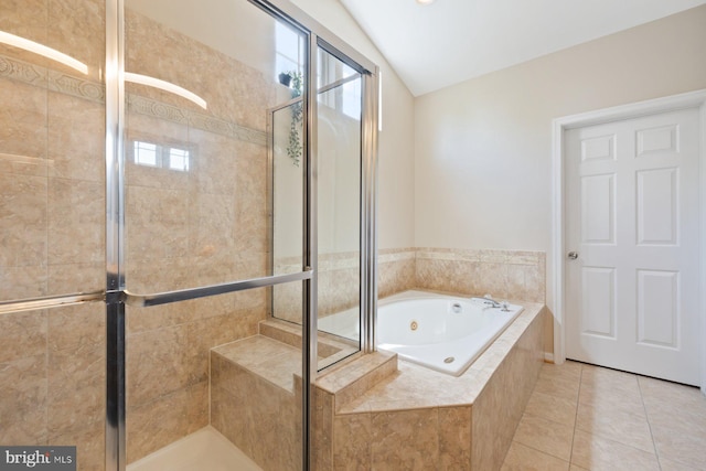 bathroom featuring a jetted tub, a shower stall, tile patterned floors, and lofted ceiling