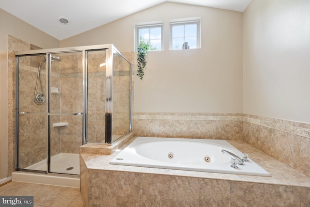 bathroom with a shower stall, vaulted ceiling, and a jetted tub