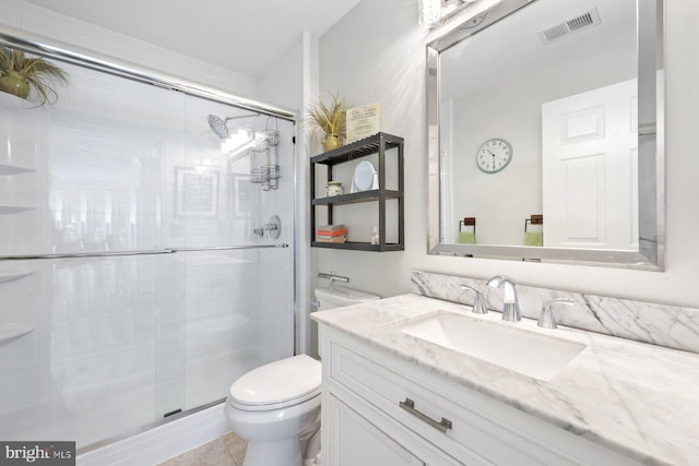 full bathroom with toilet, vanity, and a shower stall