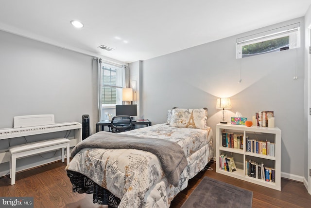 bedroom with multiple windows, recessed lighting, wood finished floors, and baseboards