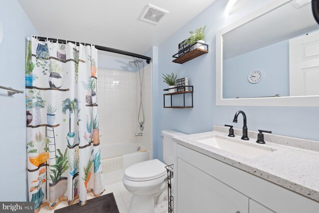 bathroom with toilet, vanity, shower / bath combo with shower curtain, and tile patterned floors