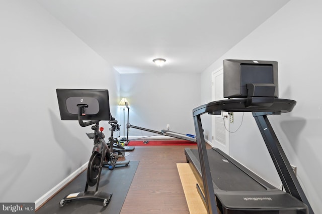 exercise room with wood finished floors and baseboards