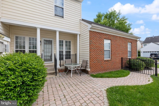 rear view of property featuring brick siding and fence