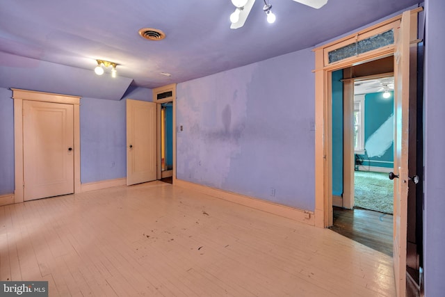 unfurnished bedroom featuring baseboards, visible vents, and hardwood / wood-style flooring