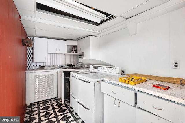 kitchen featuring open shelves, electric stove, dark floors, light countertops, and white cabinetry