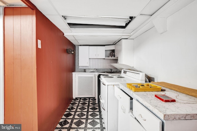 interior space with washer / dryer, cabinet space, and dark floors