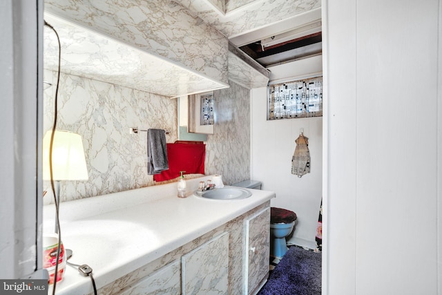 bathroom featuring toilet and vanity