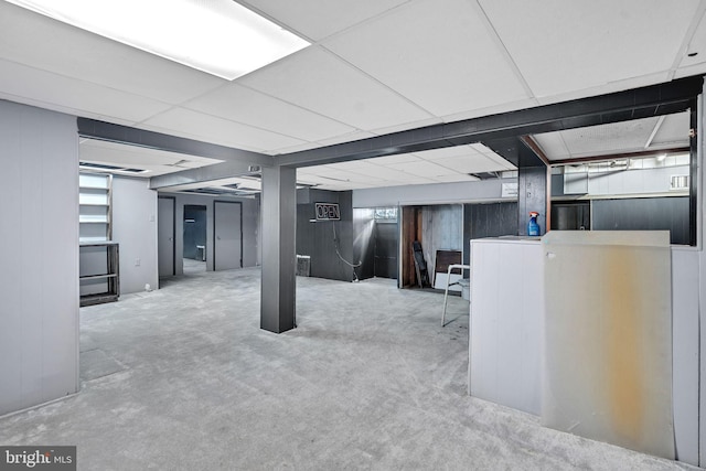 basement with carpet floors and a drop ceiling