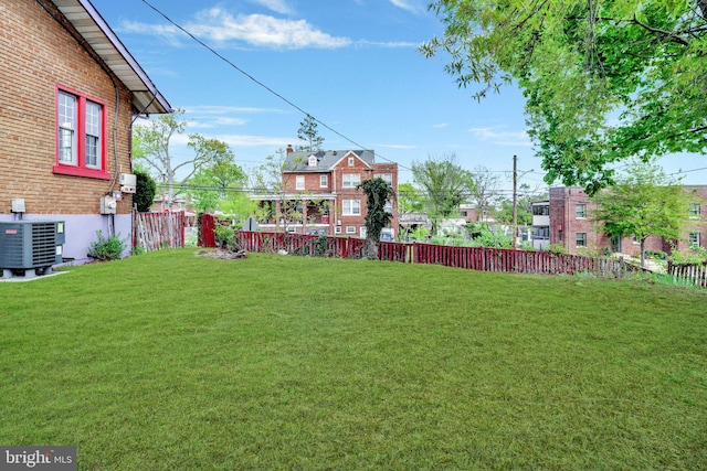 view of yard featuring a fenced backyard and central AC unit