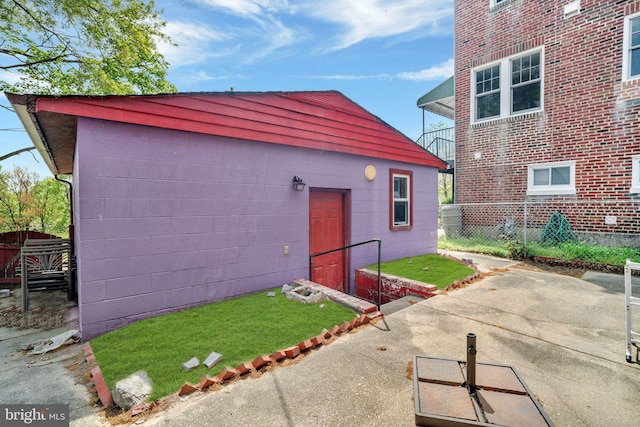 view of outbuilding featuring fence