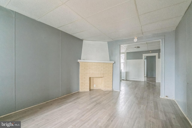 3905 L St, Philadelphia, PA 19124 - unfurnished living room featuring a drop ceiling, wood finished floors, and a fireplace