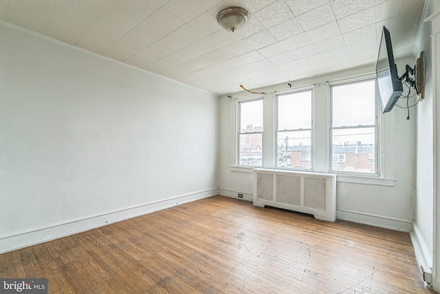 3905 L St, Philadelphia, PA 19124 - empty room featuring plenty of natural light, baseboards, hardwood / wood-style floors, and radiator
