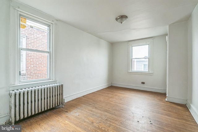 3905 L St, Philadelphia, PA 19124 - spare room with radiator heating unit, wood finished floors, and baseboards