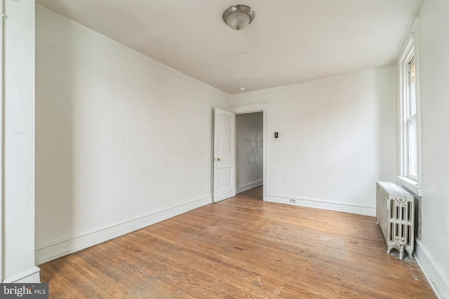 3905 L St, Philadelphia, PA 19124 - unfurnished room featuring wood finished floors, radiator heating unit, and baseboards