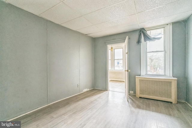 3905 L St, Philadelphia, PA 19124 - empty room with a paneled ceiling, wood finished floors, and radiator heating unit