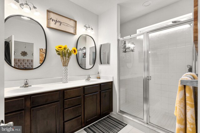 7204 Wood Trail Dr, Lanham, MD 20706 - bathroom featuring a shower stall, tile patterned floors, double vanity, and a sink