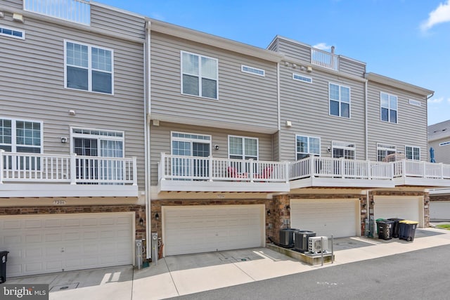 7204 Wood Trail Dr, Lanham, MD 20706 - back of house with a garage and central AC