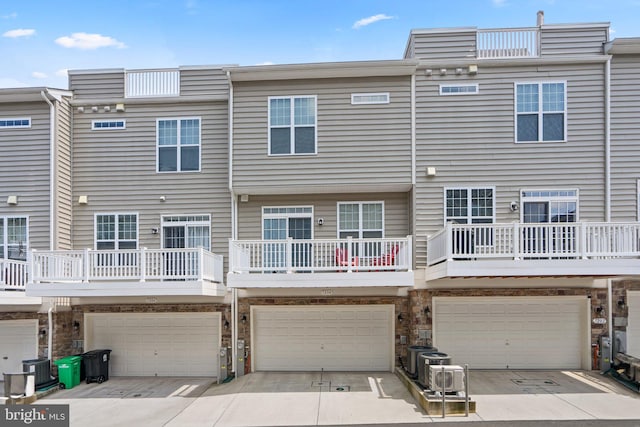 7204 Wood Trail Dr, Lanham, MD 20706 - rear view of house featuring an attached garage, driveway, and central AC