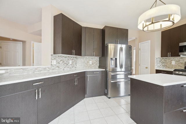 kitchen featuring dark brown cabinetry, appliances with stainless steel finishes, tasteful backsplash, and light countertops