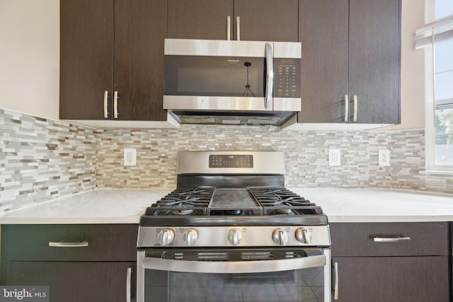 kitchen with light countertops, appliances with stainless steel finishes, and dark brown cabinetry