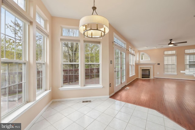 unfurnished sunroom featuring visible vents, a notable chandelier, and french doors