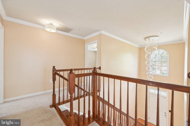 hall with baseboards, carpet flooring, an upstairs landing, and crown molding