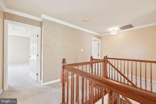 hall featuring crown molding, an upstairs landing, carpet, baseboards, and visible vents