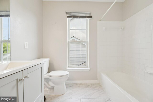 full bath featuring vanity, a wealth of natural light, marble finish floor, and toilet
