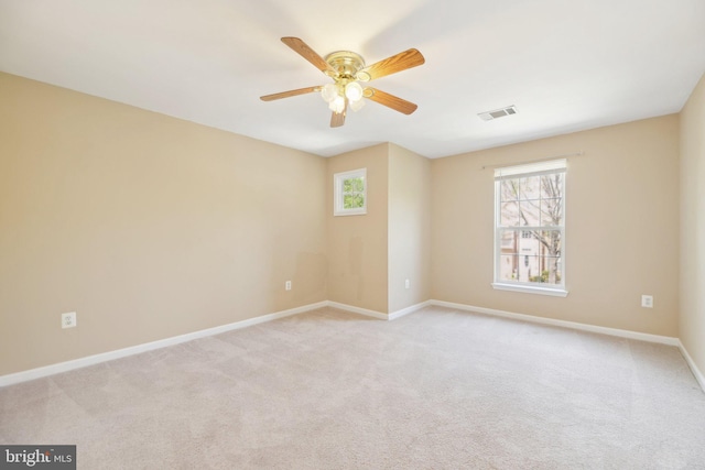 unfurnished room featuring baseboards, a ceiling fan, visible vents, and a healthy amount of sunlight