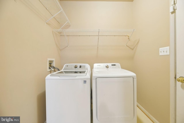 laundry area with washer and clothes dryer and laundry area