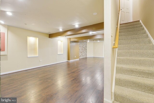 stairway with wood-type flooring, baseboards, and recessed lighting