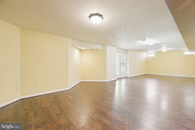 unfurnished room featuring baseboards and wood finished floors