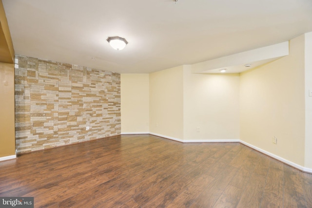 finished basement featuring baseboards and wood finished floors