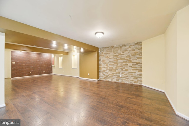 unfurnished room with hardwood / wood-style floors and baseboards