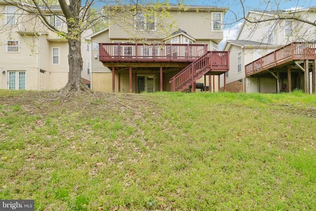 back of house featuring a wooden deck and stairway