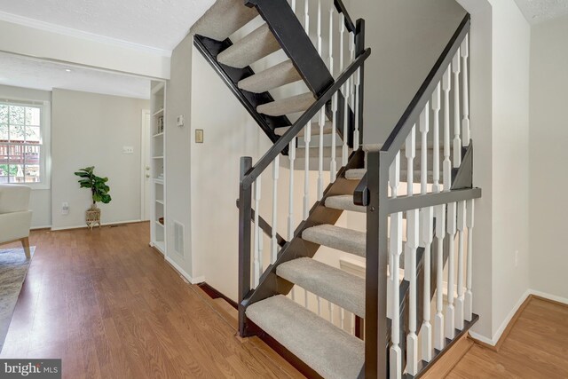 stairs with baseboards and wood finished floors
