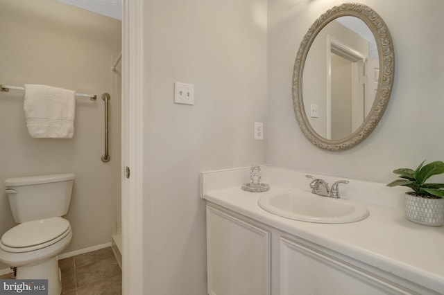 full bath with vanity, tile patterned flooring, toilet, baseboards, and walk in shower