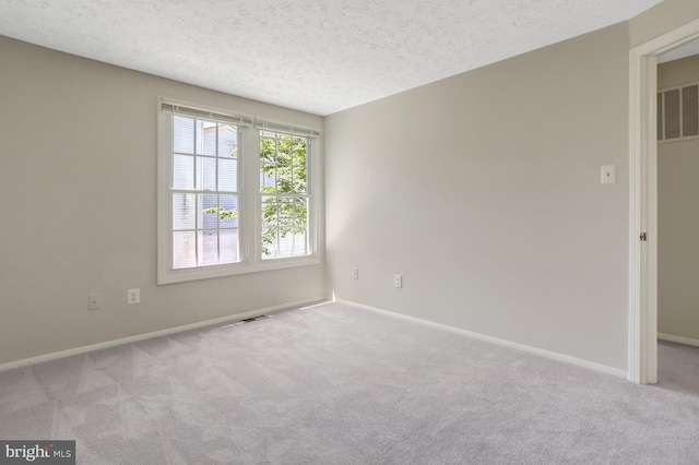 unfurnished room with carpet flooring, baseboards, and visible vents