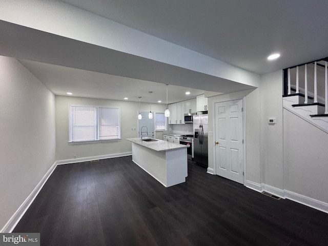 110 N Mount Olivet Ln, Baltimore, MD 21229 - kitchen with dark wood-type flooring, white cabinets, appliances with stainless steel finishes, a sink, and baseboards