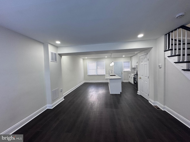 110 N Mount Olivet Ln, Baltimore, MD 21229 - unfurnished living room with recessed lighting, stairway, dark wood-type flooring, visible vents, and a sink