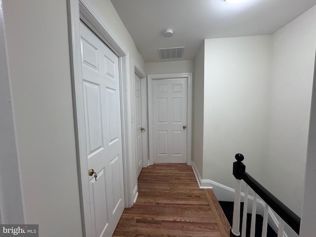 110 N Mount Olivet Ln, Baltimore, MD 21229 - hallway featuring an upstairs landing, visible vents, baseboards, and dark wood-style floors