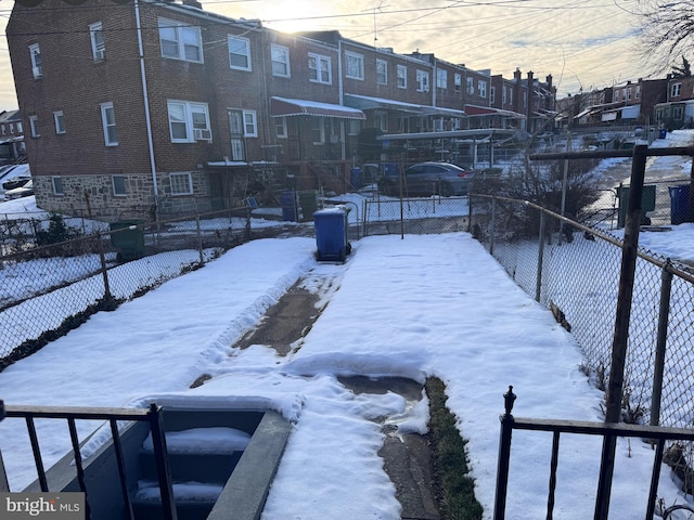 110 N Mount Olivet Ln, Baltimore, MD 21229 - yard layered in snow with fence and a residential view