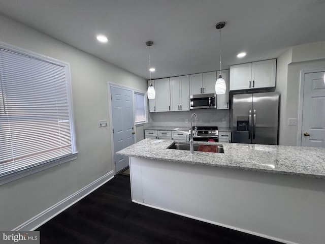 110 N Mount Olivet Ln, Baltimore, MD 21229 - kitchen with a sink, appliances with stainless steel finishes, white cabinetry, light stone countertops, and dark wood-type flooring