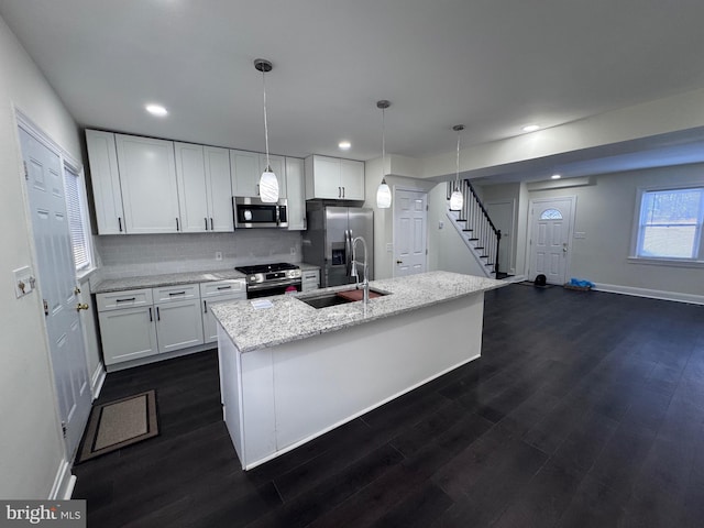 110 N Mount Olivet Ln, Baltimore, MD 21229 - kitchen featuring a sink, dark wood-style floors, baseboards, and stainless steel appliances