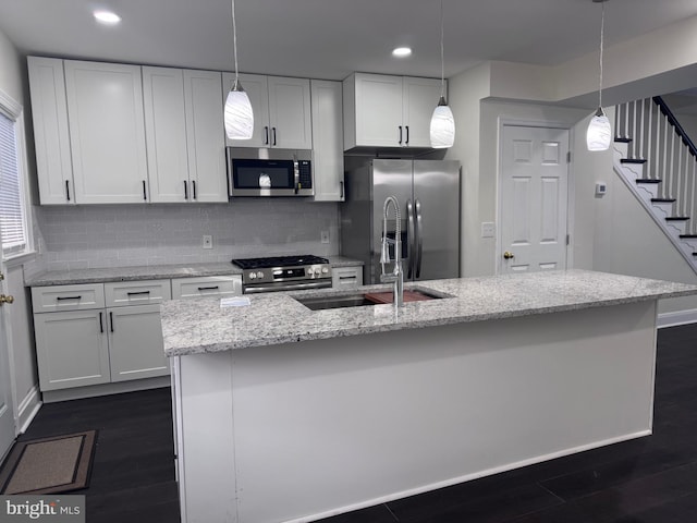 110 N Mount Olivet Ln, Baltimore, MD 21229 - kitchen featuring stainless steel appliances, white cabinetry, decorative backsplash, and dark wood finished floors