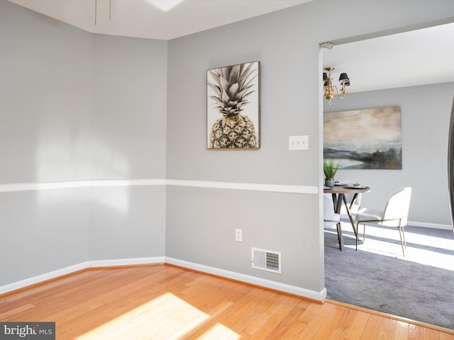 1161 Bacon Ridge Rd, Crownsville, MD 21032 - empty room with hardwood / wood-style floors, baseboards, and a chandelier
