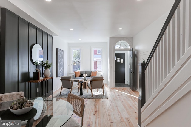 foyer with light wood-type flooring, baseboards, recessed lighting, and stairs